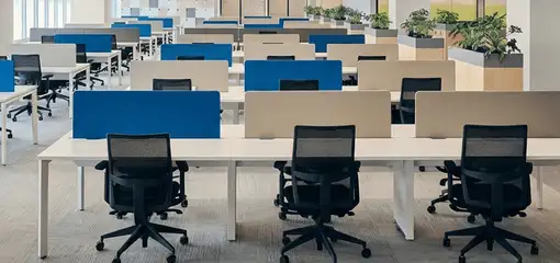 Modern open-plan office space featuring clean workstations, ergonomic chairs, and sanitized carpets provided by professional office cleaning services in Tacoma, WA.