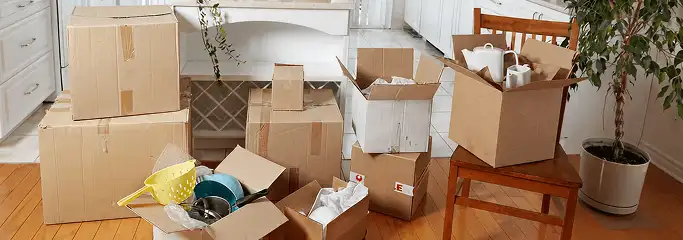 Packed moving boxes and household items in a kitchen before move-out or move-in cleaning, Tacoma, WA.